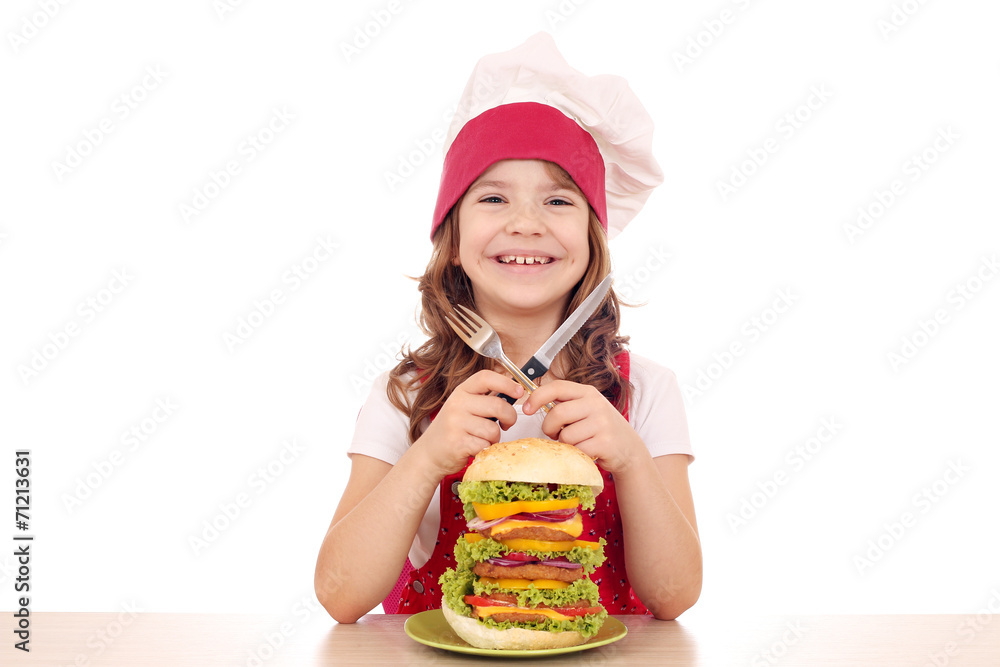 little girl cook with big hamburger on table little girl cook with big hamburger on table