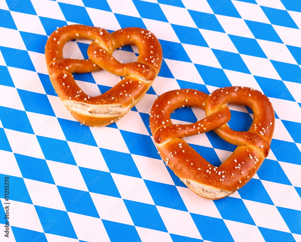Two pretzel in heart shape on white blue background Two pretzel in heart shape on white blue background