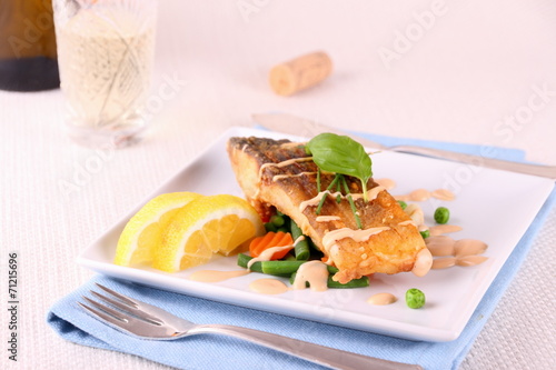 Fried carp fish fillet with vegetables, wine
