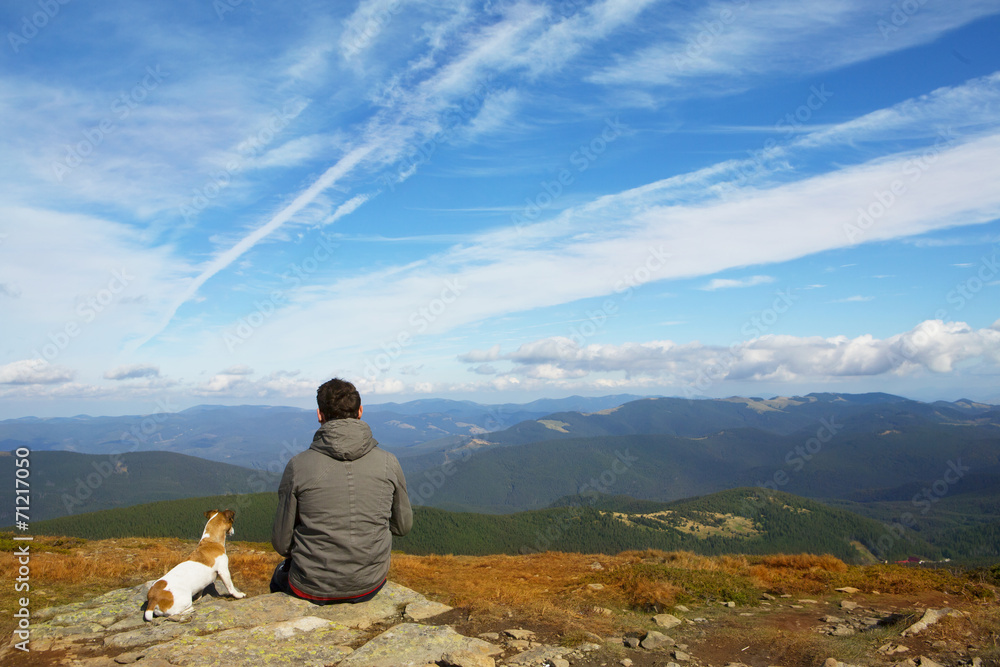 man and dog traveling in nature
