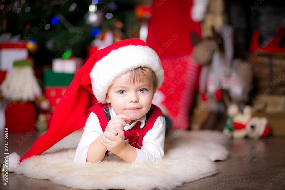 happy little boy near a Christmas tree opening gifts happy little boy near a Christmas tree opening gifts