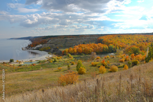 Bay of sea ​​hills on background of autumn forest and gray sky