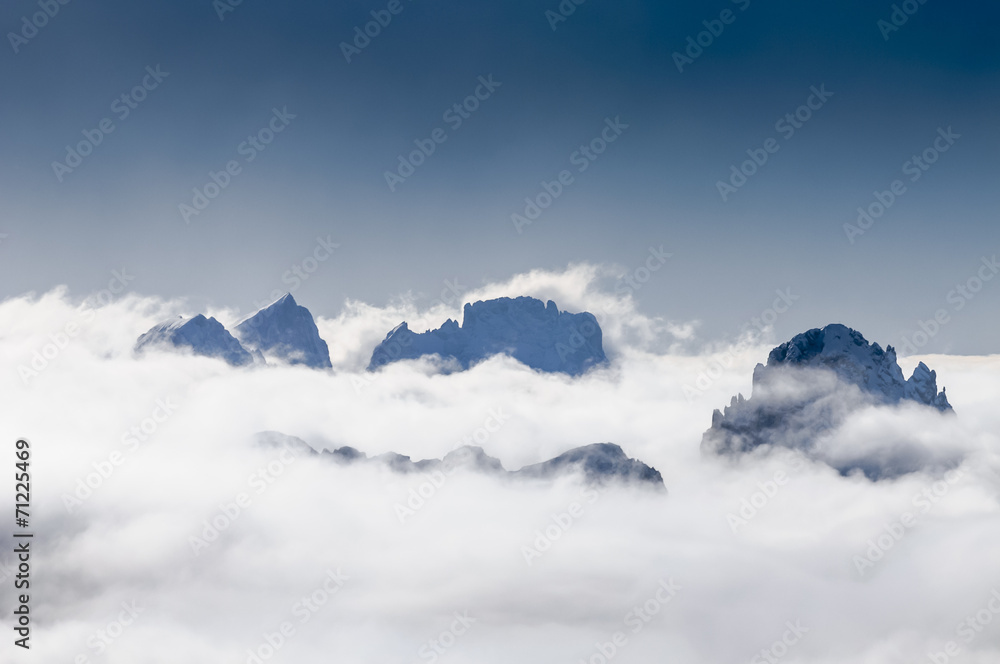 Dolomite Mountains covered with clouds in winter