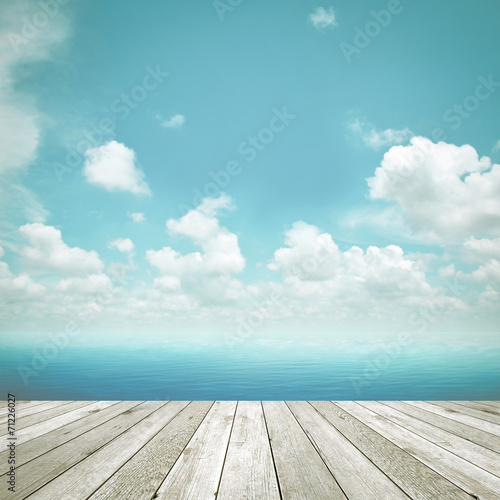 Wood plank as a pier on blue sky background - retro style