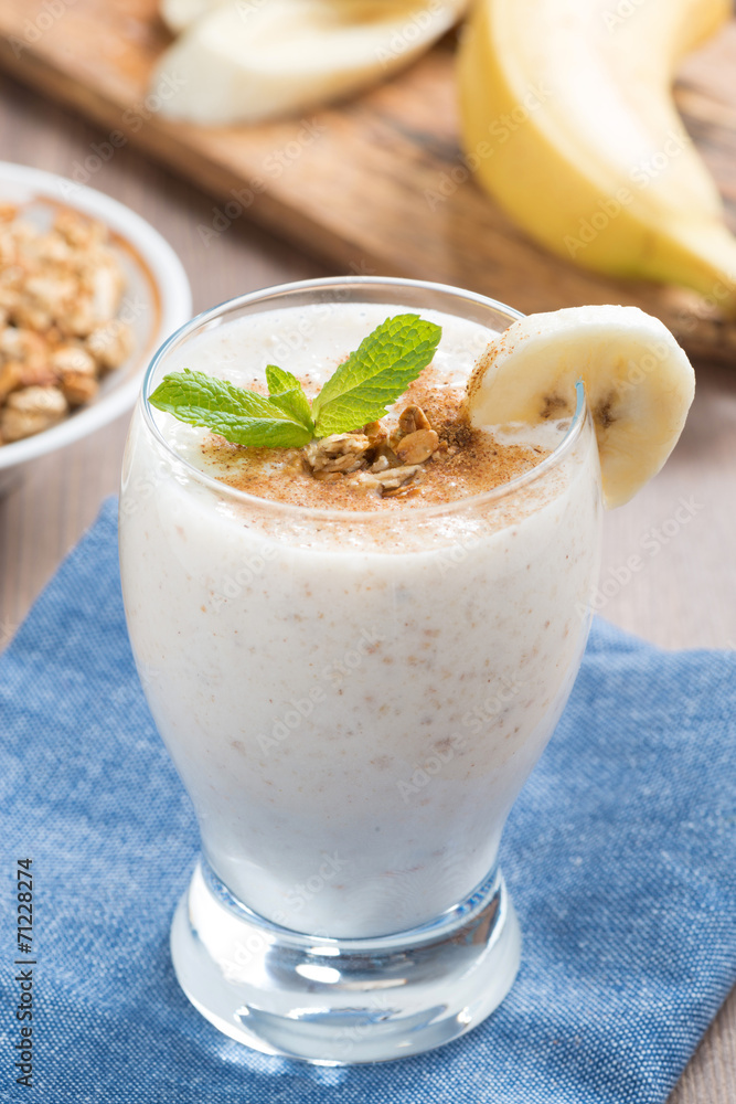 milkshake with banana, granola and cinnamon in a glass milkshake with banana, granola and cinnamon in a glass