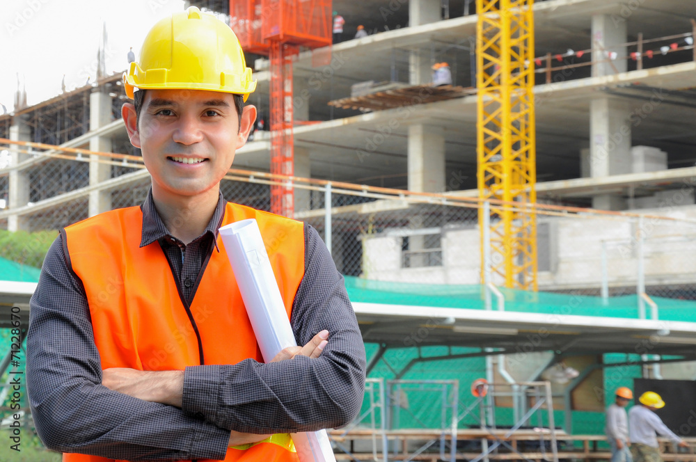 Asian engineer or foreman in front of construction site Asian engineer or foreman in front of construction site