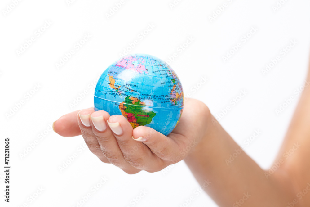woman's hand with globe woman's hand with globe