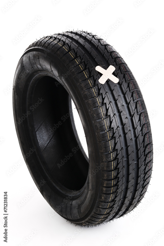 black new tire with patch on white