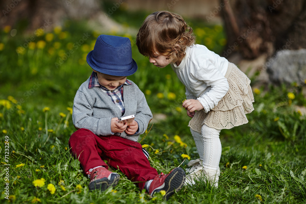 boy and girl playing with mobile phone boy and girl playing with mobile phone