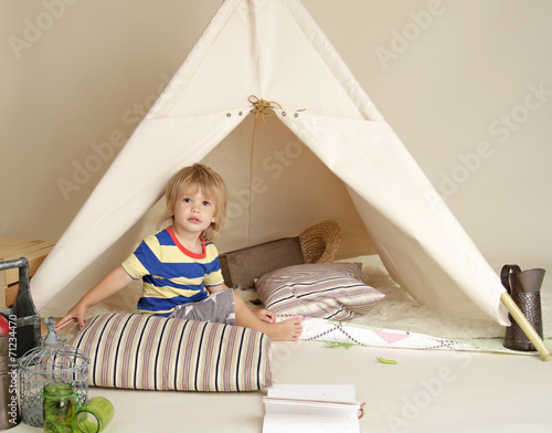 Child Playing Indoors with Teepee Tent