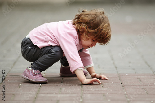 little girl lying on asphalt portrait