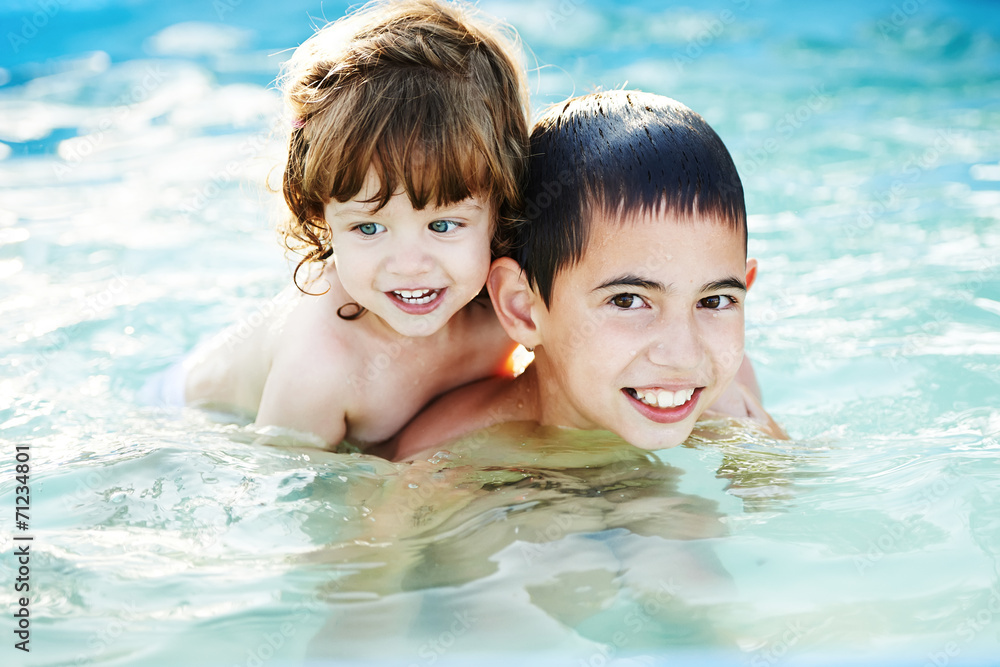 brother and sister bathe outside in pool brother and sister bathe outside in pool