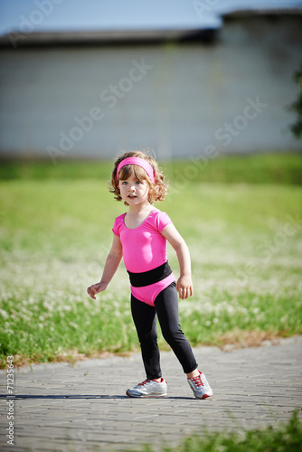 cute girl running at stadium photo