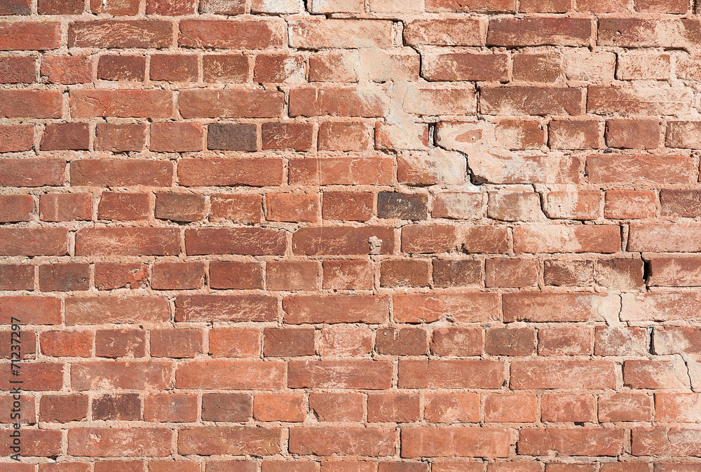 Naklejka premium Red brick with a crack background