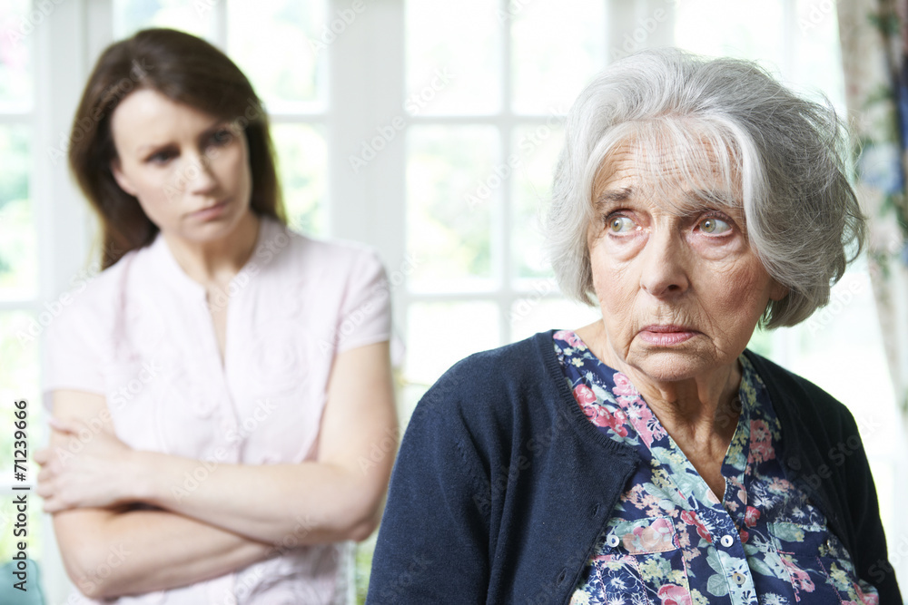 Serious Senior Woman With Adult Daughter At Home Serious Senior Woman With Adult Daughter At Home