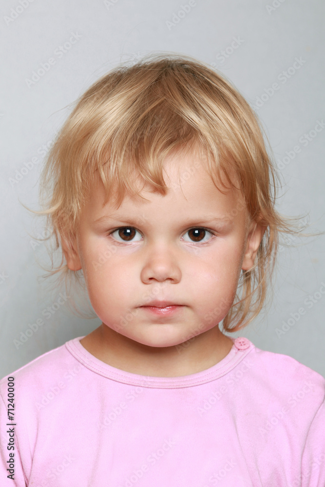 Caucasian baby girl closeup portrait. Headshot on gray Caucasian baby girl closeup portrait. Headshot on gray