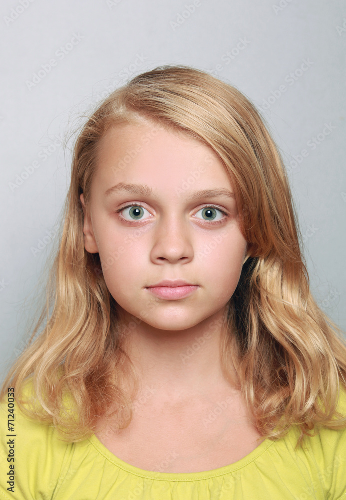 Caucasian little girl closeup portrait. Headshot on gray Caucasian little girl closeup portrait. Headshot on gray