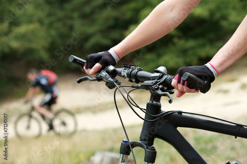Woman hands on bicycle handle bars
