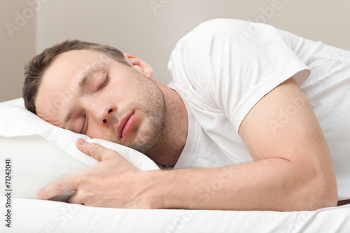 Portrait of sleeping Young Caucasian man in white