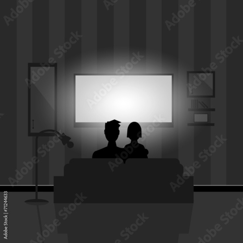 Couple watching movie on TV at night