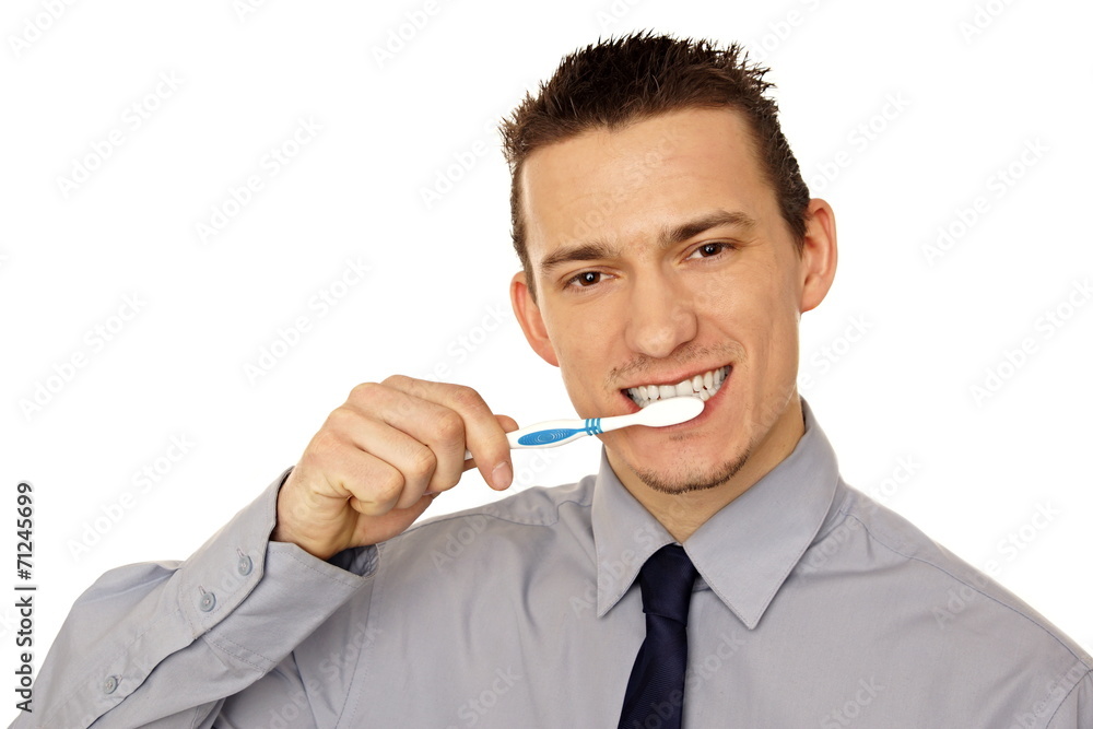 © petrdlouhy - Young businessman cleaning with toothbrush his teeth