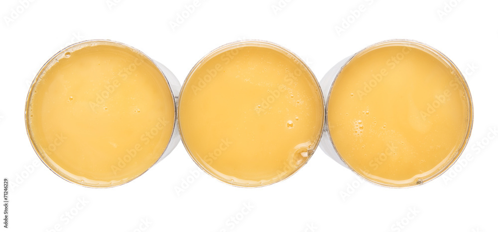 Condensed milk in tin can over white background Condensed milk in tin can over white background