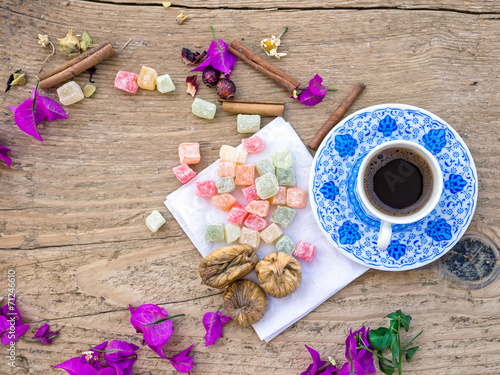 Fototapeta Naklejka Na Ścianę i Meble -  A cup of Turkish coffee with sweets and spices on a wooden surfa