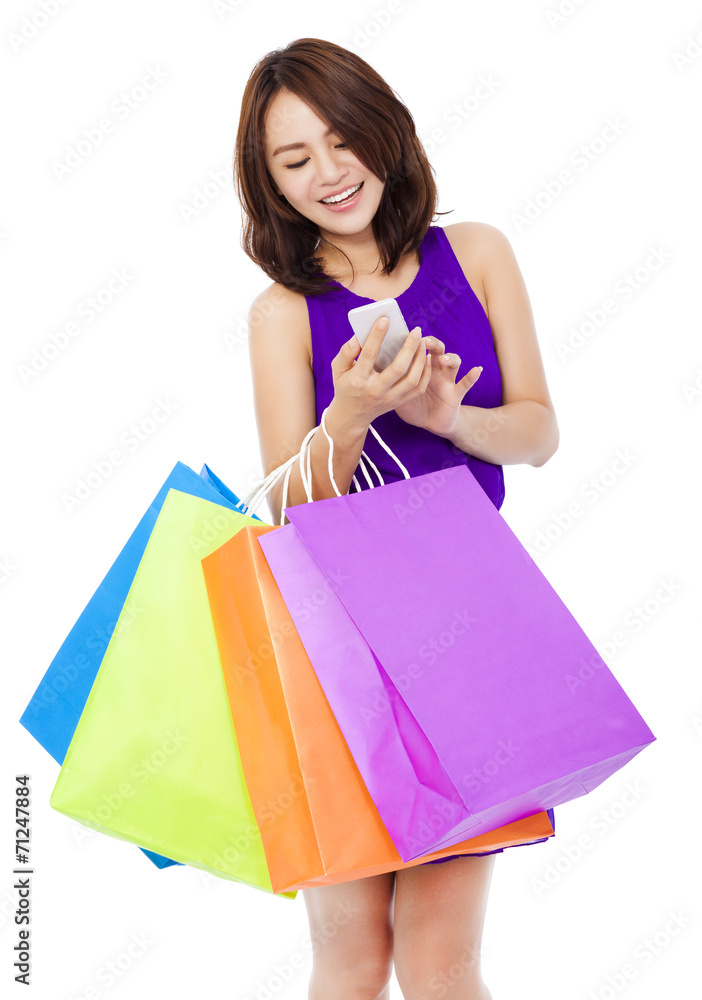 young pretty woman holding a cell phone to shop online