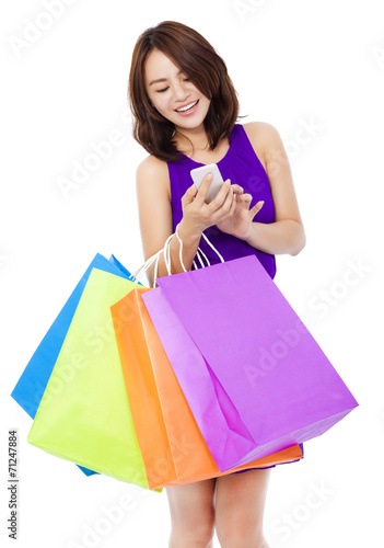 young pretty woman holding a cell phone to shop online