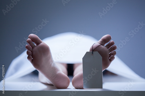 Close-up of human feet in morgue photo