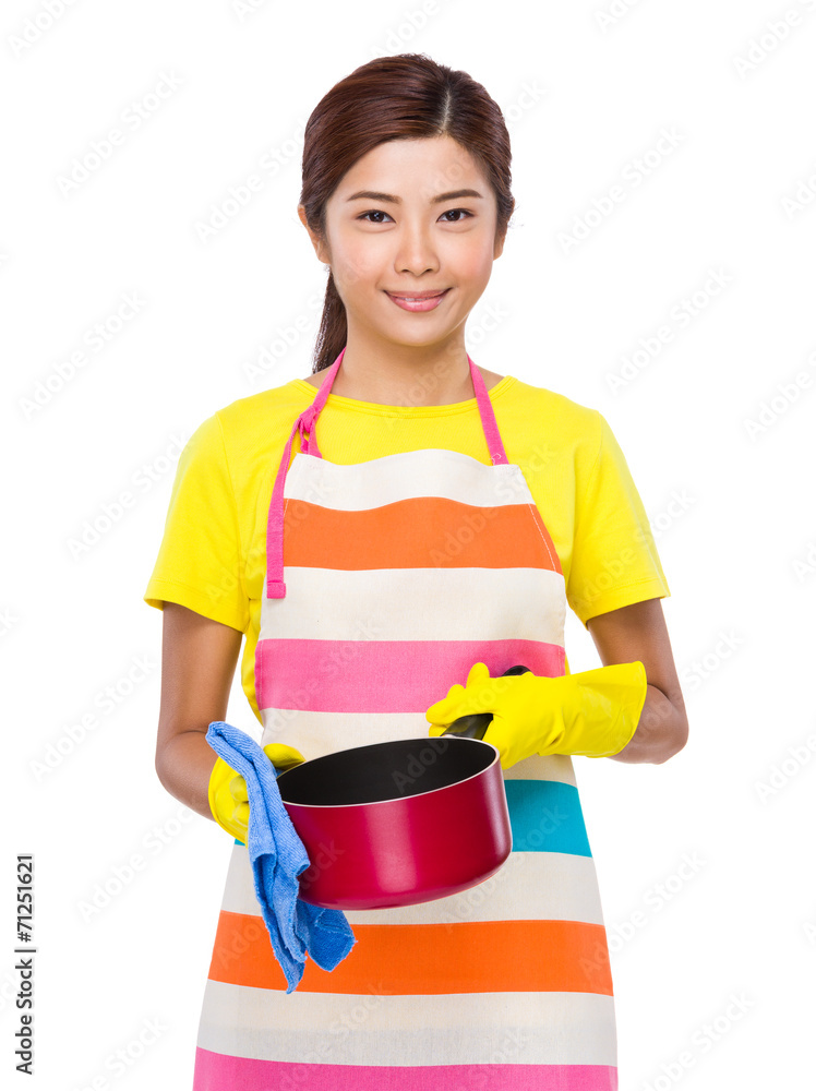 Asian housewife cleaning of saucepan Asian housewife cleaning of saucepan
