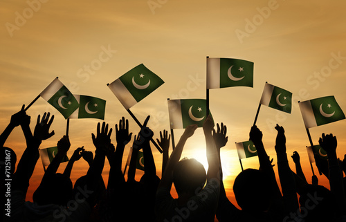 Foto Group of People Waving Flag of Pakistan in Back Lit