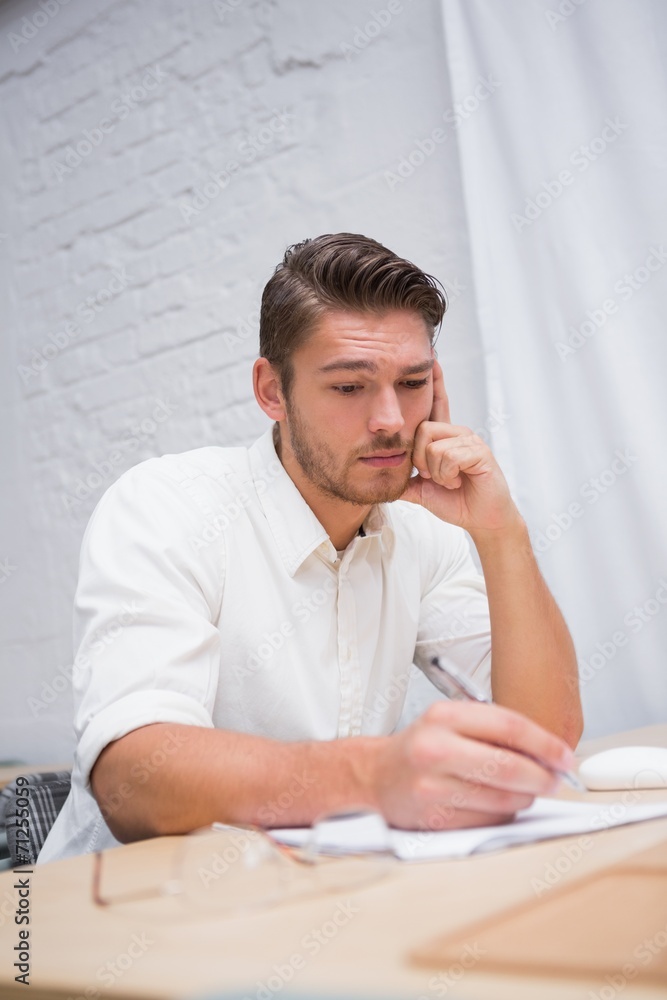 Businessman writing documents at office Businessman writing documents at office