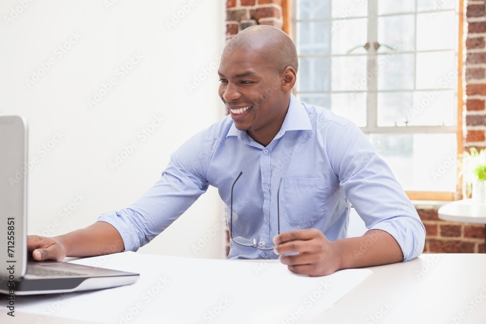 Casual businessman using his laptop at desk Casual businessman using his laptop at desk