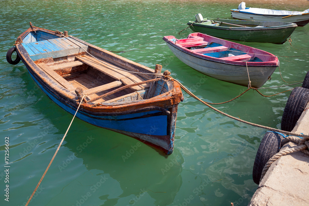 Old small wooden fishing boats moored in small Bulgarian town