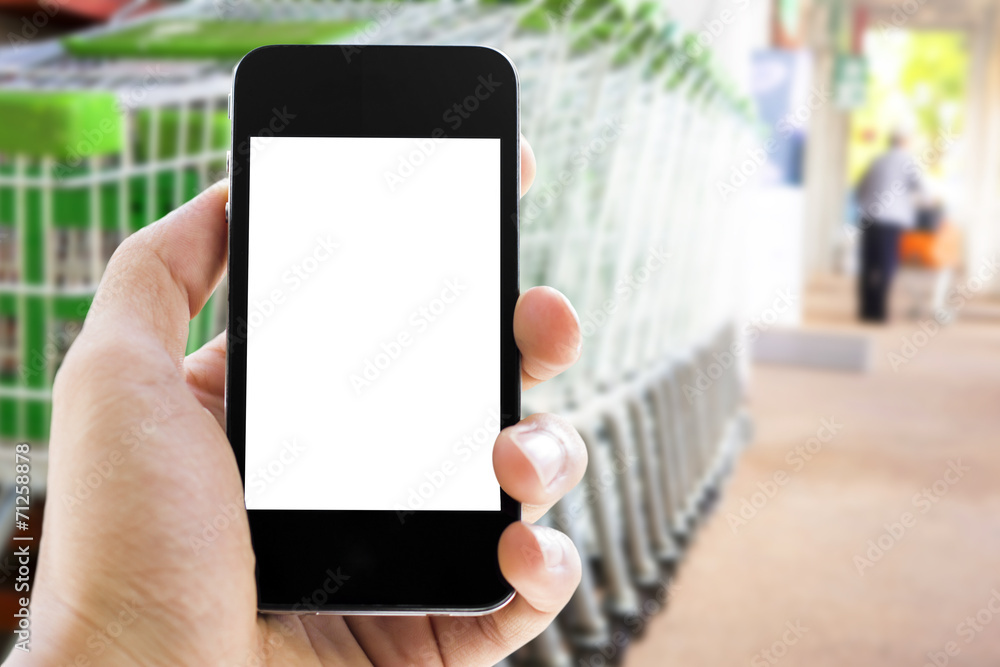 hand holding phone with shopping cart  background