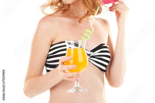 Beautiful young woman in swimsuit and hat with cocktail