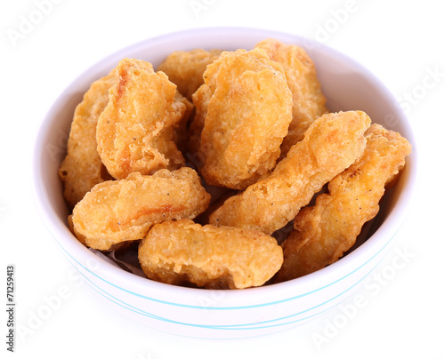 Fried chicken nuggets in bowl isolated on white