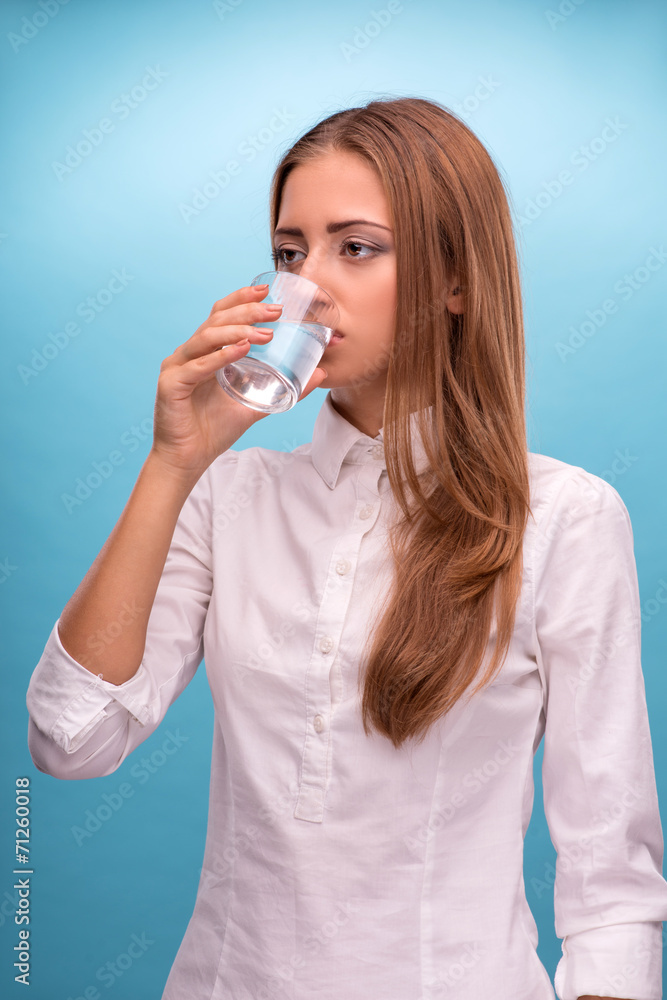 Portrait of young beautiful girl drinking clean water from a gla Portrait of young beautiful girl drinking clean water from a gla
