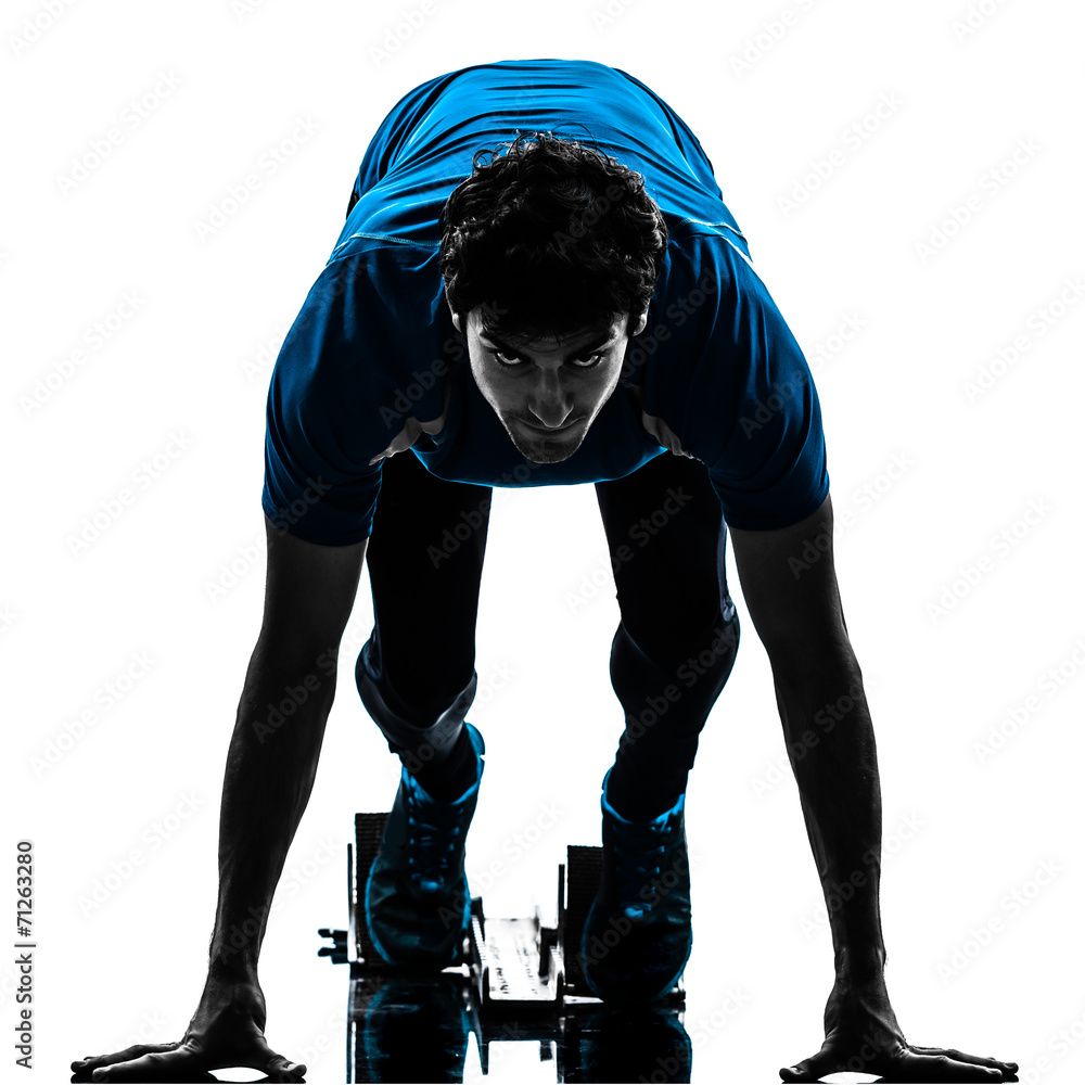 Fotografie man runner sprinter on starting blocks   silhouette