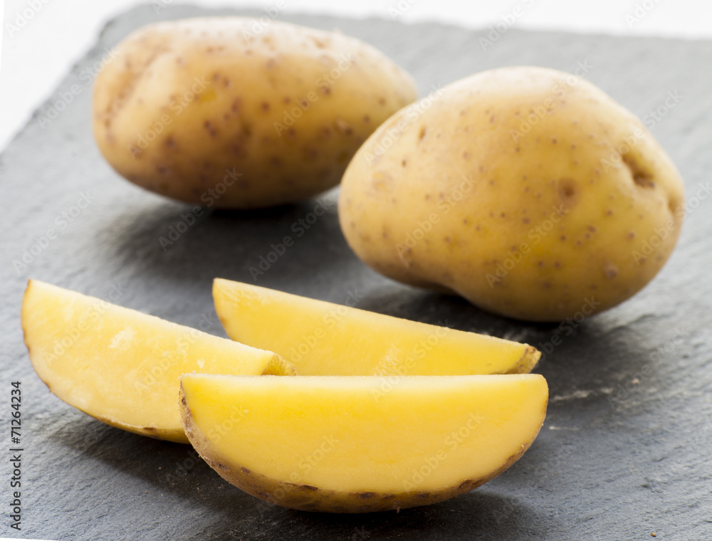 potatoes cut on black background close up
