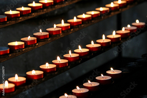 many wax candles lit in the Church during mass