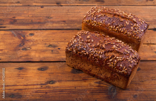 Bread with sunflower seedson the wooden table photo