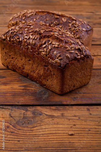 Bread with sunflower seedson the wooden table photo