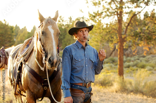 Cowboy with cigar and his horse © JEANNE