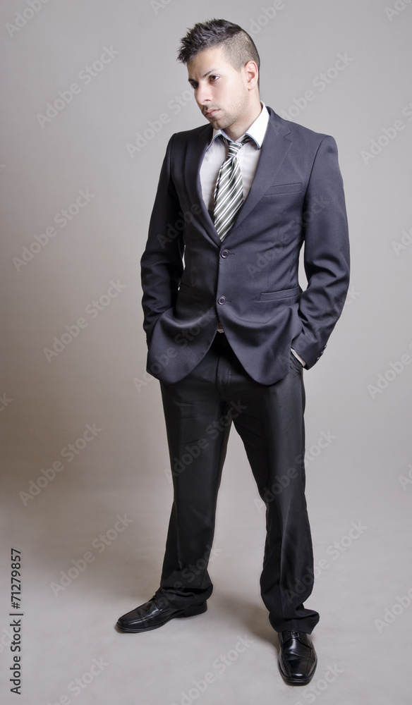 Posing suit young man in full length portrait Posing suit young man in full length portrait