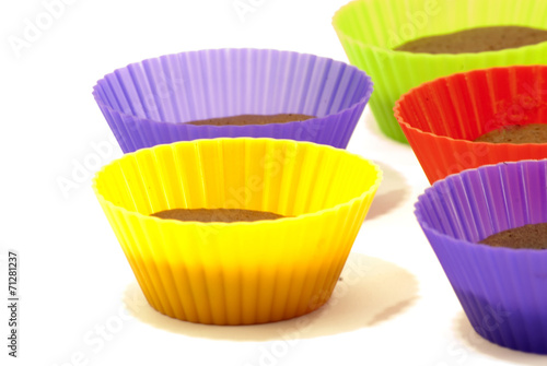 Chocolate muffins in silicone holders of many colors