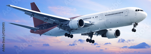 Fotografie Aircraft is in a sunset sky