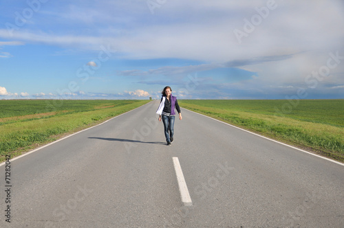 Young girl walking on the highway