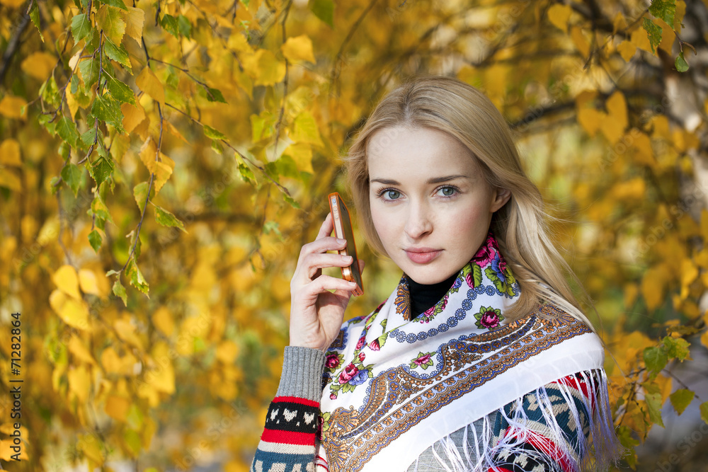 Portrait of a beautiful young woman calling by phone